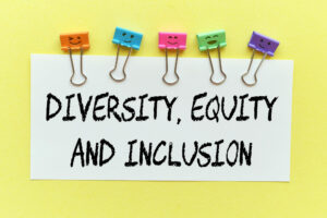 white-note-with-word-diversity-equity-inclusion-yellow-background